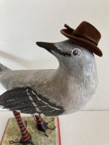 paperclay mocking bird with brown cowboy hat