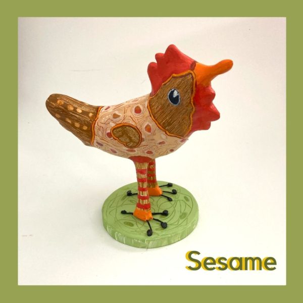 paperclay bird sculpture painted in acrylics and mounted on a wooden stand.