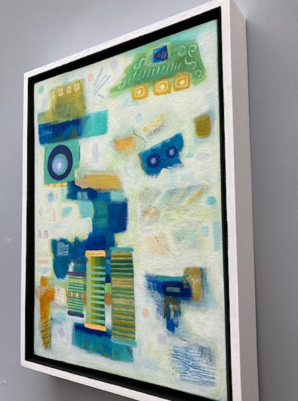 Side view of the yellow green and blue abstract painting showing the wood frame.