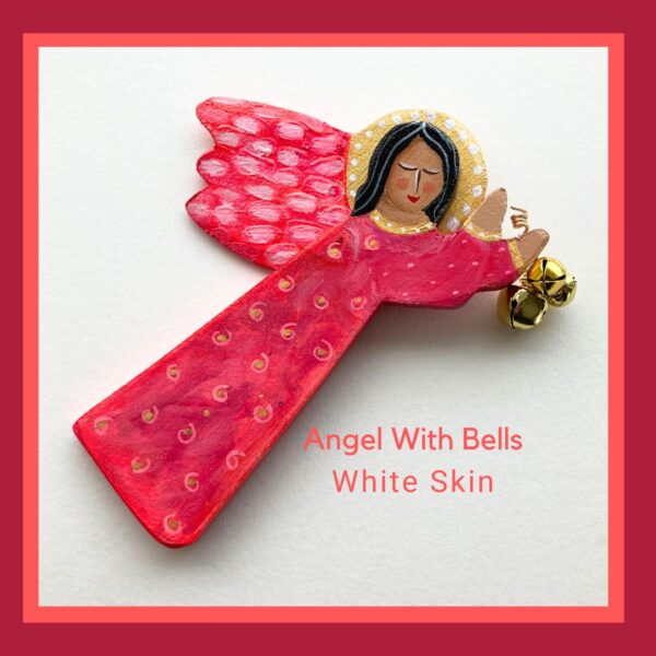 A white skin flying wood angel ornament holding 3 bells. She is wearing a bright red and pink dress with a dot and circle pattern.