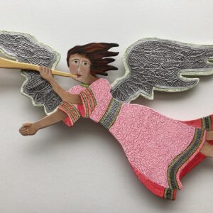 Red and pink wood flying angel on a pole with a base. Decorative sculpture. This angel is flying from right to left.