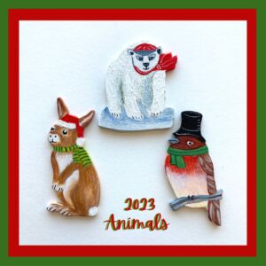 Three animal ornaments. A polar bear, a Little red finch and a brown rabbit.