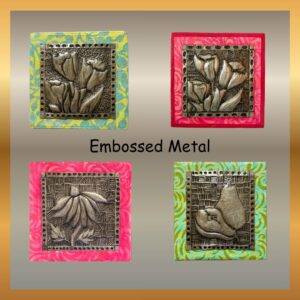 embossed aluminum art depicting fruit and flowers mounted on wood